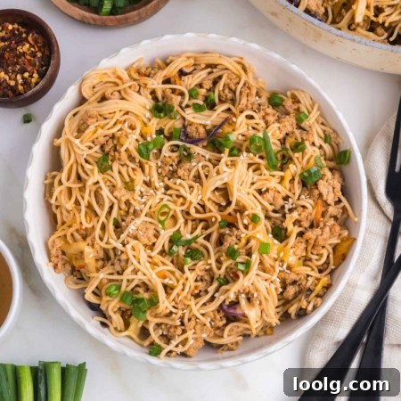 Sticky Honey Garlic Noodles with Sesame and Scallions 8 honey garlic noodles in a white bowl on a white table