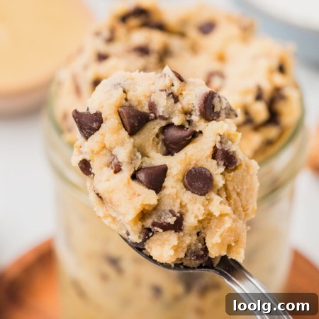 spoon digging into a jar of cottage cheese cookie dough