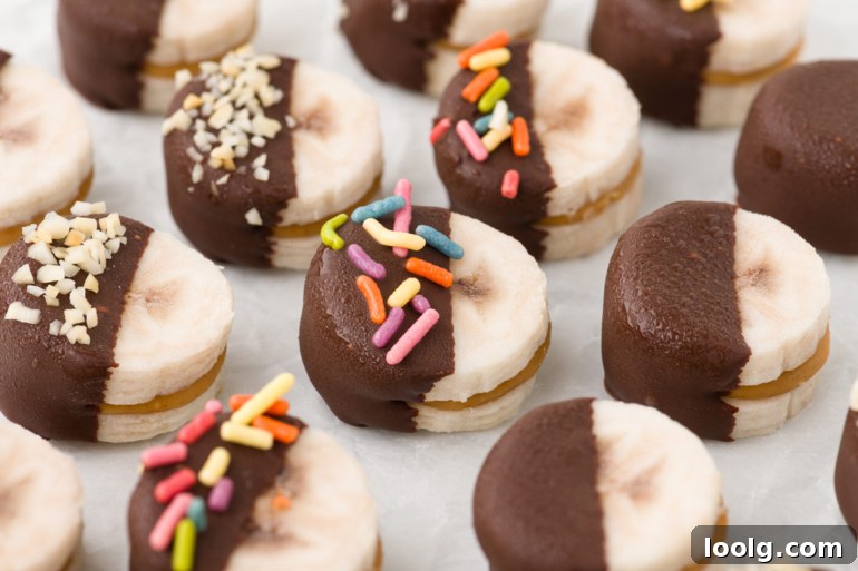 Peanut Butter Banana Bites: No-Bake Frozen Snack 3 peanut butter bananas with sprinkles and chopped nuts on them