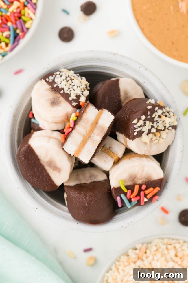 Peanut Butter Banana Bites: No-Bake Frozen Snack 5 white bowl filled with peanut butter bananas on a white table with sprinkles and peanut butter in the background