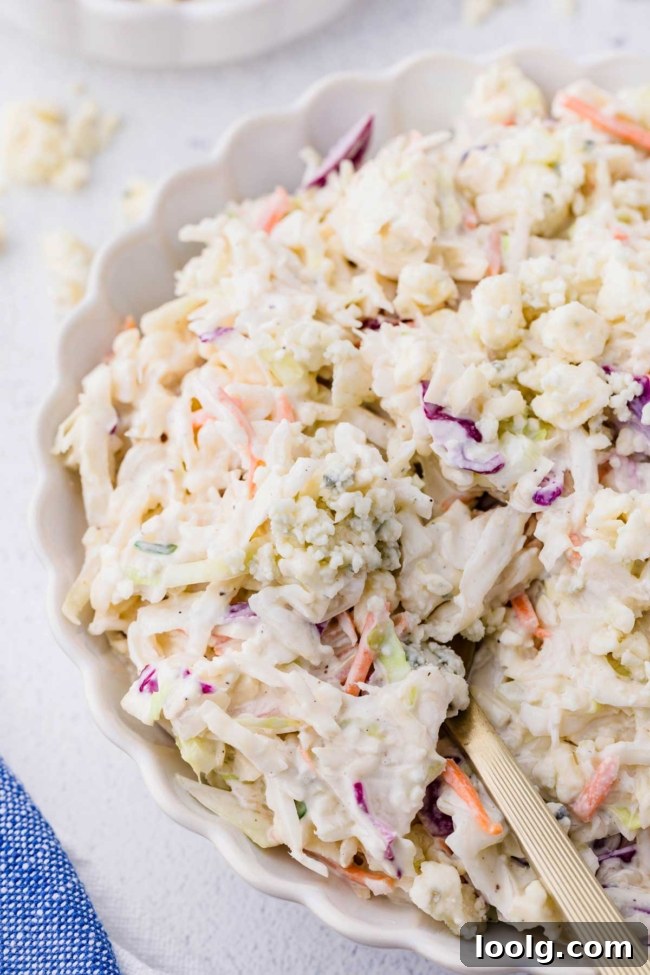 Creamy Blue Cheese Coleslaw with Tangy Dressing 6 close up of blue cheese slaw in a white bowl