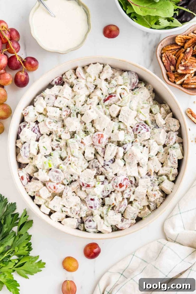 Creamy Chicken Salad with Grapes for Summer Lunch 3 white bowl filled with chicken salad with grapes with more ingredients in background