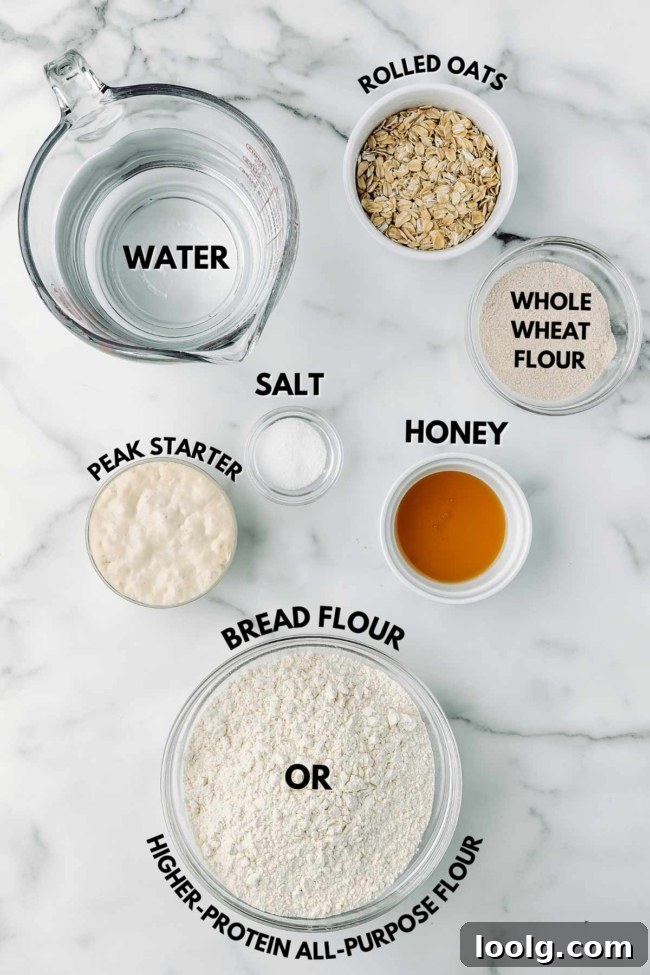 ingredients laid out to make honey oat sourdough on a marble table