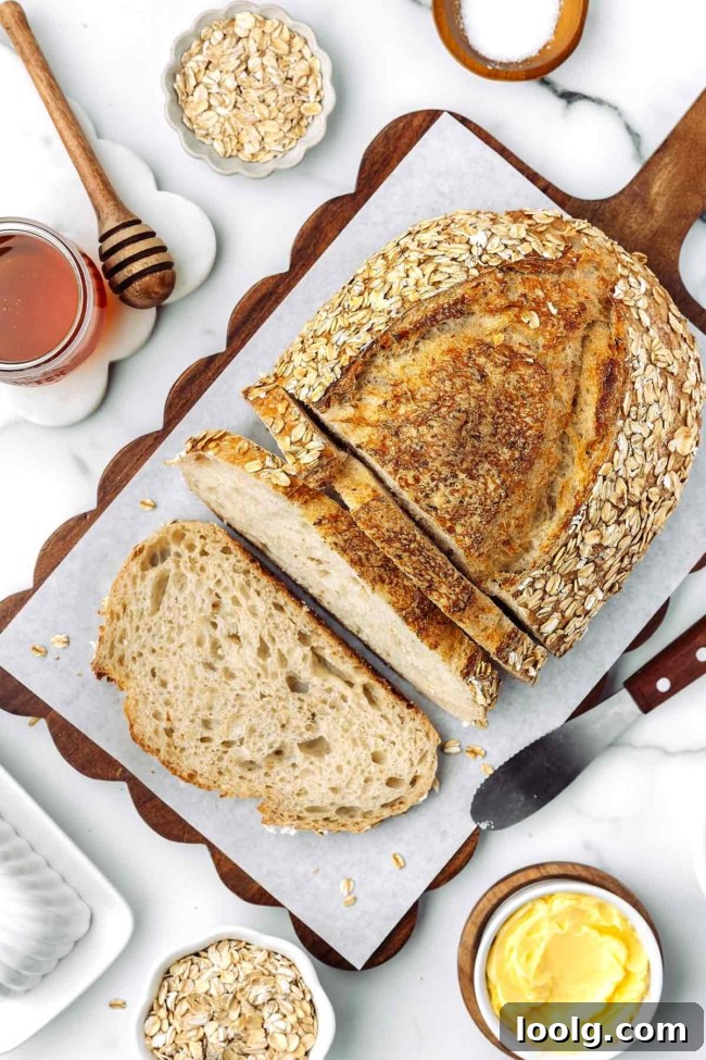 overhead shot of sliced up honey oatmeal sourdough bread on a cutting board