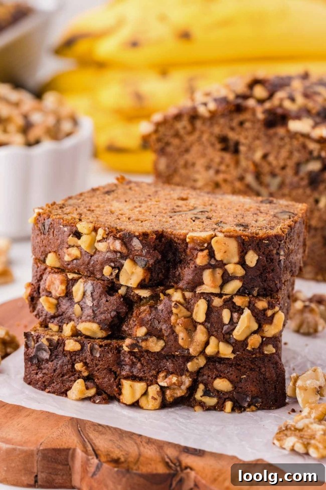Stack of 3 whole wheat banana nut bread slices on a white plate